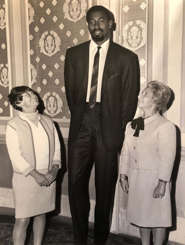 Sylvia W. Kauders with friend Sally Berlin reaching the heights of 7&amp;#39;1&amp;quot; Wilt Chamberlain in Philaldephia&amp;#39;s celebration of&amp;nbsp;

his&amp;nbsp;100&amp;ndash;point&amp;nbsp;game with the Philadelphia Warriors defeating the New York Knicks on March 2, 1962.